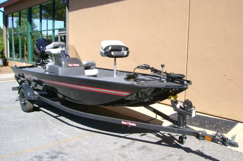The Image of 2027 Tracker Bass Tracker Classic XL fishing boat on trailer, parked outdoors. - 0