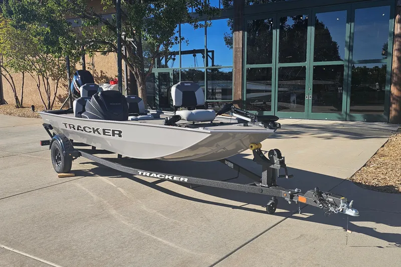 The Image of 2027 Tracker Pro 170 boat on trailer, parked outdoors near a building. - 0