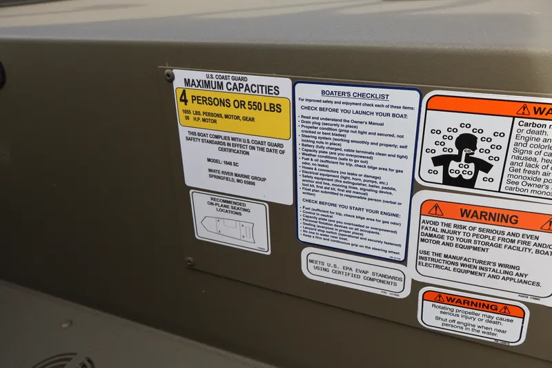 Slide: The Image of 2027 Tracker Grizzly 1648 SC boat safety and capacity labels with warnings and checklist. - 18