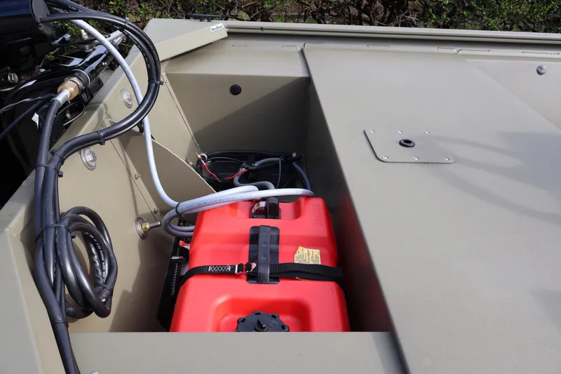 Slide: The Image of 2027 Tracker Grizzly 1648 SC boat interior with red fuel tank and wiring. - 17