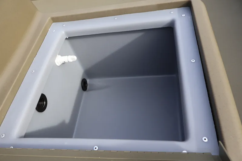 Slide: The Image of 2027 Tracker Grizzly 1648 SC boat storage compartment with drainage features. - 16