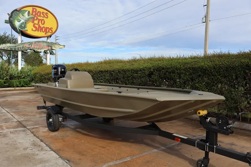 The Image of 2027 Tracker Grizzly 1648 SC boat on trailer at Bass Pro Shops parking lot. - 0