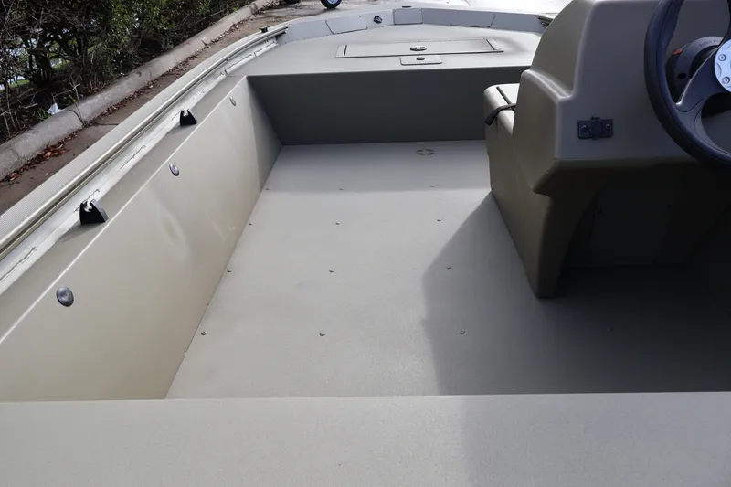 Slide: The Image of 2027 Tracker Grizzly 1648 SC boat interior with steering console and spacious deck. - 13