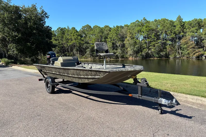The Image of 2027 Tracker Grizzly 1754 SC boat on trailer by a scenic lake. - 0