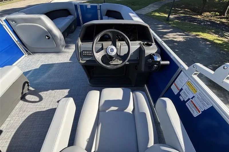 Slide: The Image of 2027 Sun Tracker Party Barge 18 DLX interior with steering console and seating. - 21