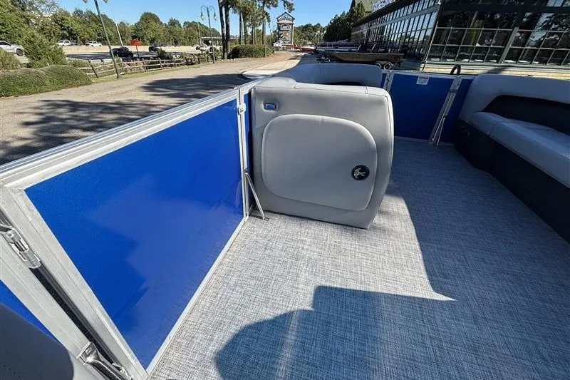 Slide: The Image of 2027 Sun Tracker Party Barge 18 DLX interior with blue panels and gray seating. - 16