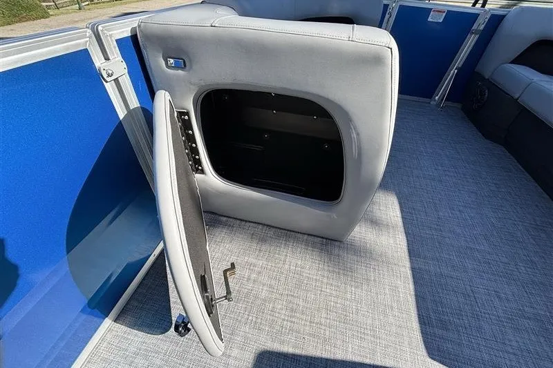 Slide: The Image of 2027 Sun Tracker Party Barge 18 DLX interior storage compartment with open seat. - 17