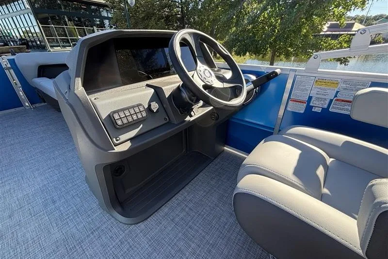 Slide: The Image of 2027 Sun Tracker Party Barge 18 DLX helm with steering wheel and seating. - 20