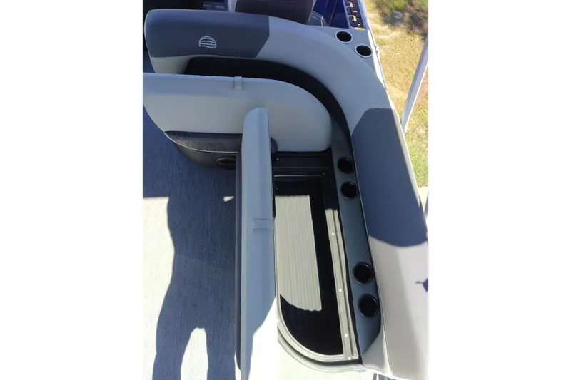 Slide: The Image of Sun Tracker Bass Buggy 18 DLX 2027 boat seating with storage and cup holders. - 14
