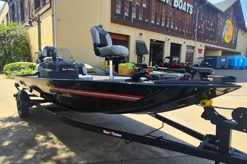 The Image of 2027 Tracker Bass Tracker Classic XL boat on trailer outside a store. - 0