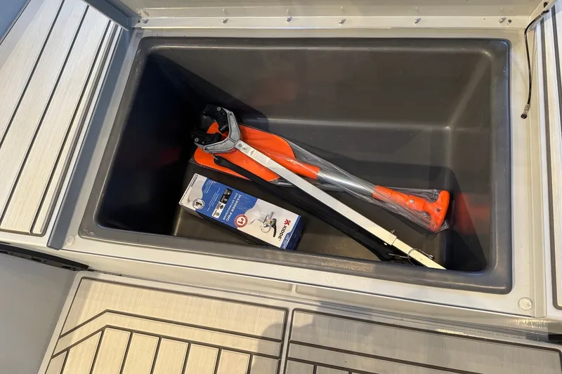 Slide: The Image of Storage compartment of 2027 Tracker Bass Tracker 175 CC with tools and accessories. - 15
