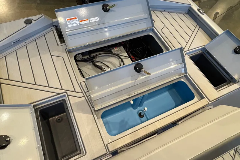 Slide: The Image of 2027 Tracker Bass Tracker 175 CC boat storage compartments and livewell, showcasing organized interior layout. - 19