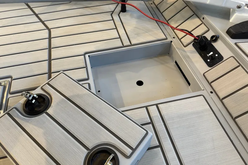 Slide: The Image of 2027 Tracker Bass Tracker 175 CC boat deck with open hatch and wiring details. - 13