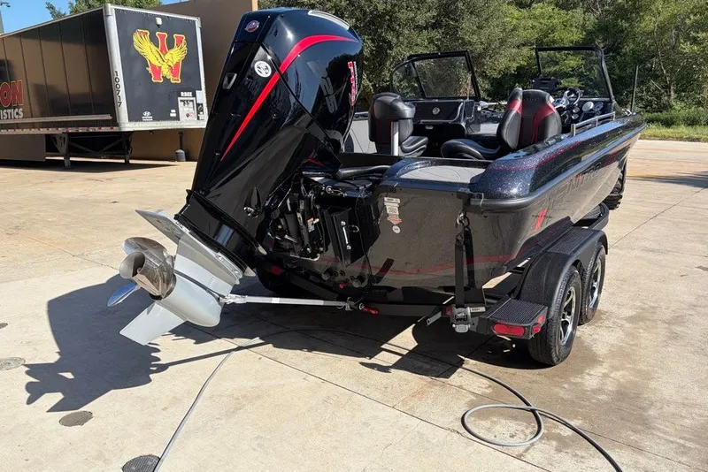 Slide: The Image of Nitro ZV19 Pro 2027 boat with powerful outboard motor, parked on a trailer. - 19