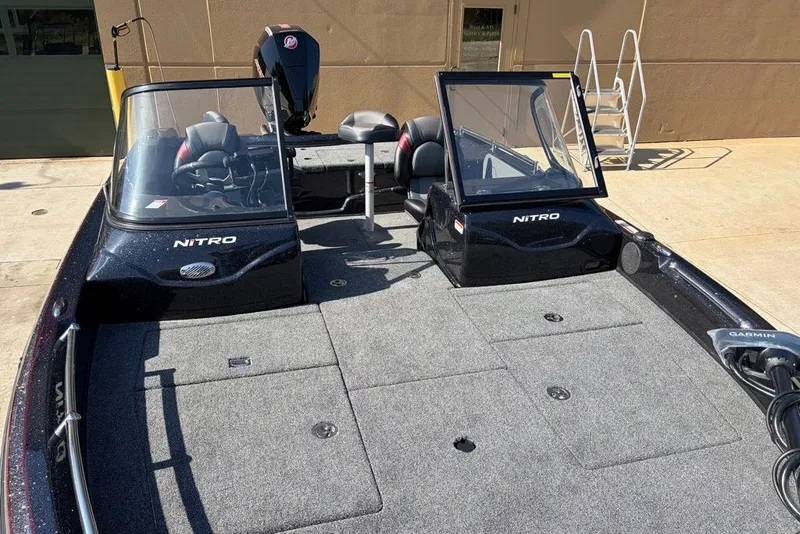 Slide: The Image of 2027 Nitro ZV19 Pro boat with dual windshields and spacious deck, parked outdoors. - 5