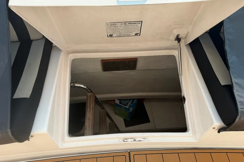 Slide: The Image of Open hatch on 2004 Neptunus 56 Flybridge yacht, revealing interior storage space. - 56
