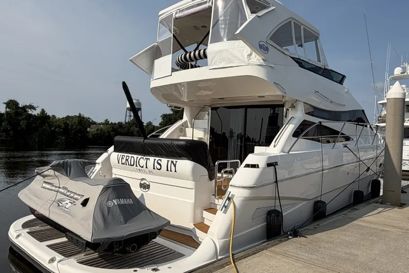 Slide: The Image of 2004 Neptunus 56 Flybridge yacht docked with Yamaha jet ski on platform. - 2