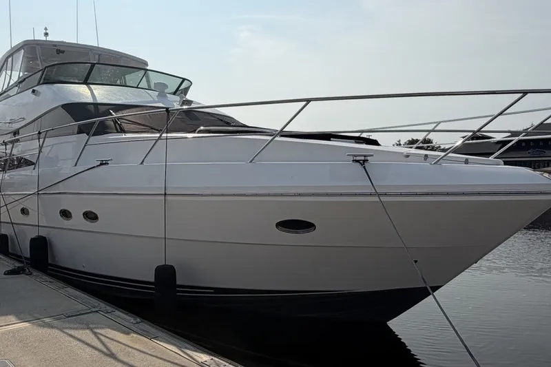 Slide: The Image of 2004 Neptunus 56 Flybridge yacht docked at marina, side view. - 3
