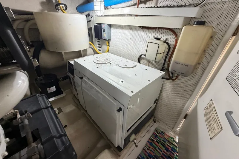 Slide: The Image of Engine room of 2004 Neptunus 56 Flybridge yacht, featuring machinery and equipment. - 62
