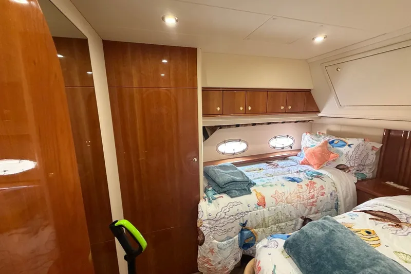 Slide: The Image of Luxurious 2004 Neptunus 56 Flybridge yacht cabin with twin beds and nautical decor. - 43