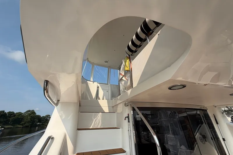 Slide: The Image of Staircase leading to flybridge on 2004 Neptunus 56 yacht, with clear sky background. - 9