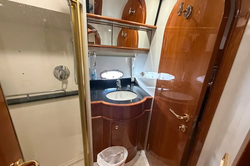 Slide: The Image of Luxurious 2004 Neptunus 56 Flybridge yacht bathroom with wood accents and modern fixtures. - 49
