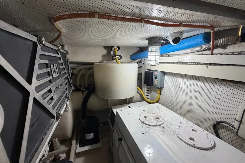 Slide: The Image of Engine room of a 2004 Neptunus 56 Flybridge yacht, featuring CAT marine power components. - 63