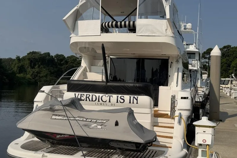 Slide: The Image of 2004 Neptunus 56 Flybridge yacht docked with jet ski on platform. - 4