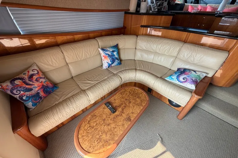 Slide: The Image of Luxurious interior of 2004 Neptunus 56 Flybridge yacht with beige leather seating and colorful pillows. - 20