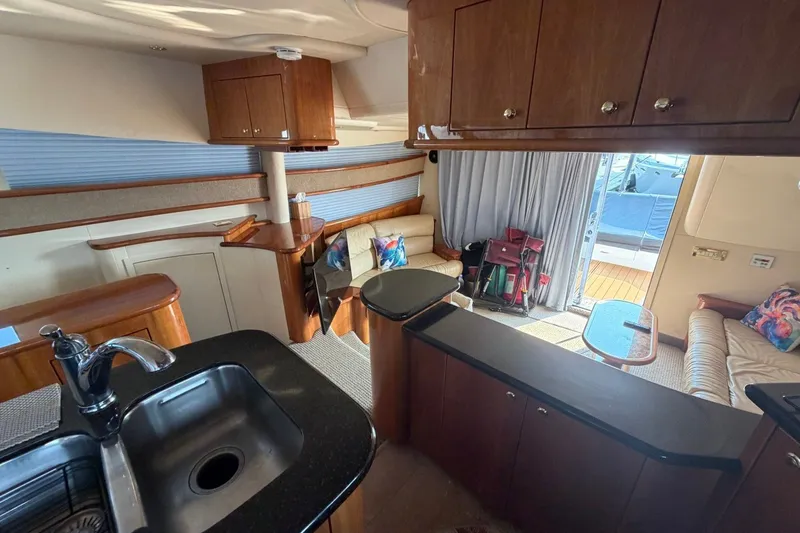 Slide: The Image of Luxurious interior of 2004 Neptunus 56 Flybridge yacht with elegant wood finishes and cozy seating. - 28