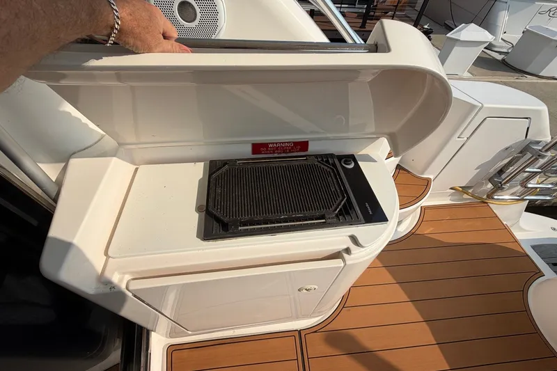 Slide: The Image of Outdoor grill on 2004 Neptunus 56 Flybridge yacht deck, featuring teak flooring. - 19