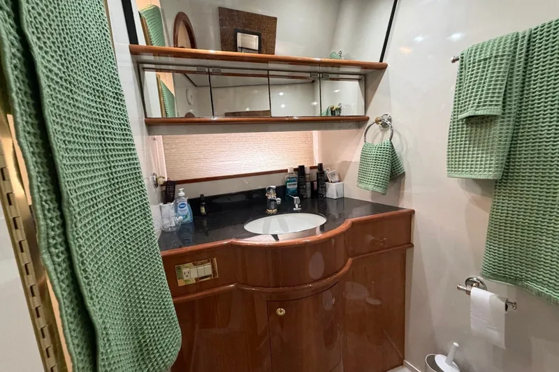 Slide: The Image of Luxurious bathroom in 2004 Neptunus 56 Flybridge yacht with green towels and elegant wood cabinetry. - 37