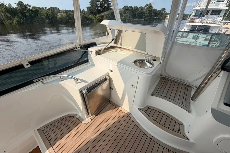 Slide: The Image of Flybridge of 2004 Neptunus 56 yacht with sink and wooden flooring. - 18