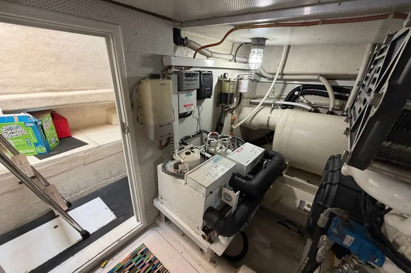 Slide: The Image of Engine room of a 2004 Neptunus 56 Flybridge yacht, showcasing mechanical components and equipment. - 61
