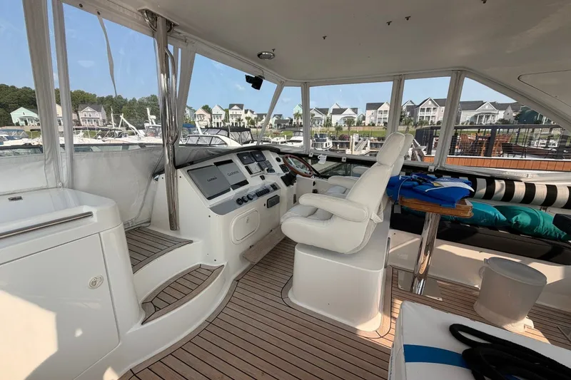 Slide: The Image of Luxurious 2004 Neptunus 56 Flybridge yacht interior with helm and seating area. - 11