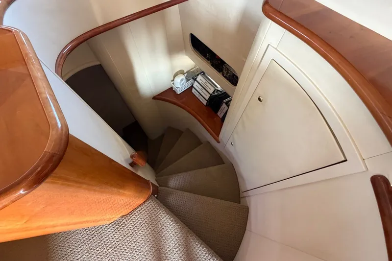 Slide: The Image of Interior staircase of 2004 Neptunus 56 Flybridge yacht with wooden accents and carpeted steps. - 32