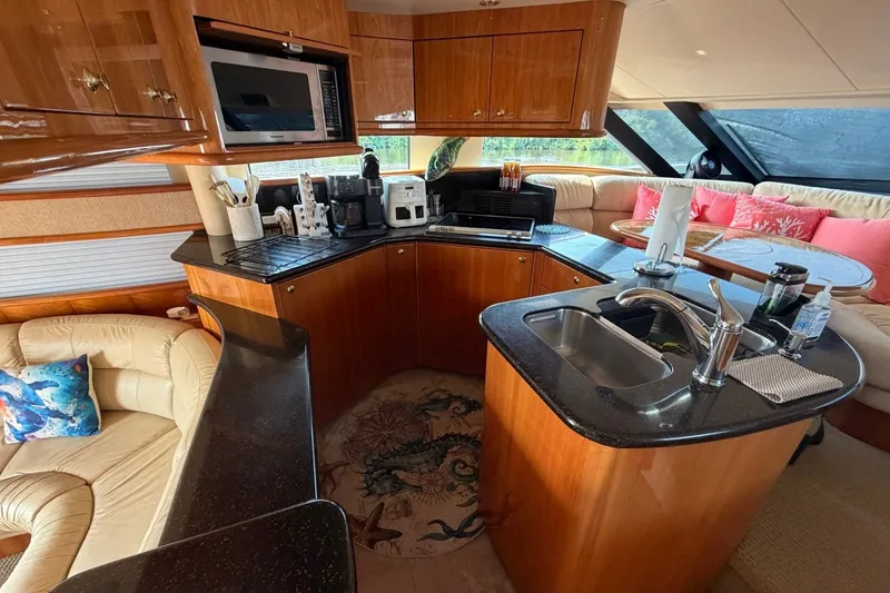 Slide: The Image of Luxurious 2004 Neptunus 56 Flybridge yacht interior with modern kitchen and cozy seating area. - 24
