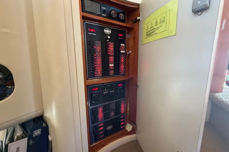 Slide: The Image of Electrical panel inside a 2004 Neptunus 56 Flybridge yacht, showcasing control systems. - 33