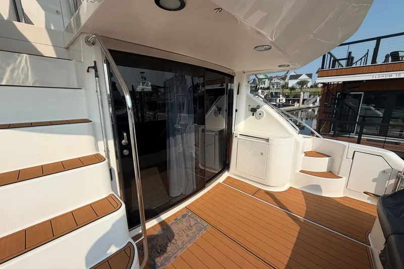 Slide: The Image of 2004 Neptunus 56 Flybridge yacht deck with teak flooring and staircase. - 10