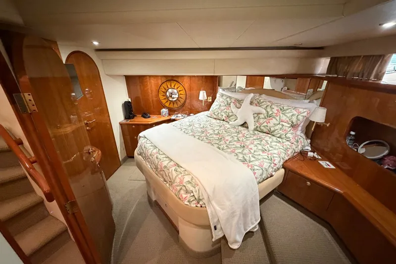Slide: The Image of Luxurious 2004 Neptunus 56 Flybridge yacht bedroom with elegant wood finishes and cozy bedding. - 39