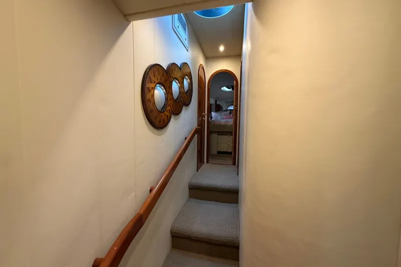 Slide: The Image of Hallway inside 2004 Neptunus 56 Flybridge yacht with nautical decor and carpeted steps. - 34