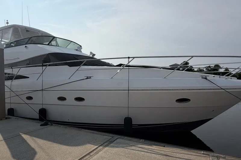 Slide: The Image of 2004 Neptunus 56 Flybridge yacht docked at marina, side view. - 1