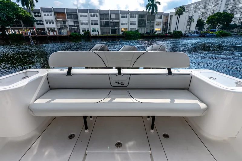 Slide: The Image of 2023 SeaVee 370Z boat with sleek seating, docked by waterfront buildings. - 50