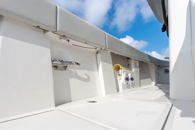 Slide: The Image of 2023 SeaVee 370Z boat deck with speakers and cleat under a blue sky. - 64