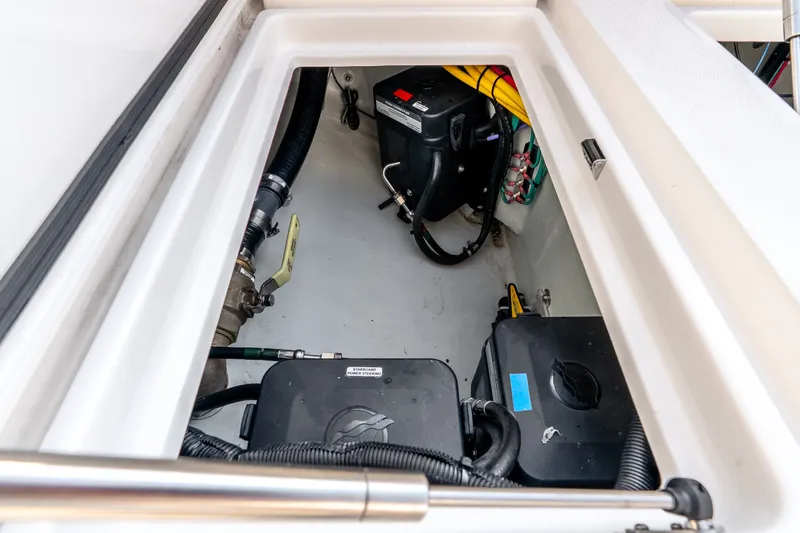 Slide: The Image of Engine compartment of 2023 SeaVee 370Z boat, showcasing internal components and wiring. - 62