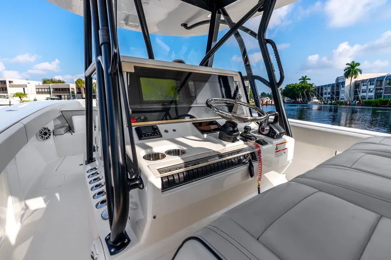 Slide: The Image of 2023 SeaVee 370Z boat cockpit with modern controls and waterfront view. - 41