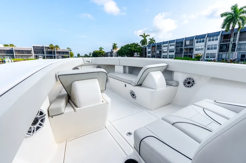 Slide: The Image of 2023 SeaVee 370Z boat interior with white seating, modern design, and waterfront view. - 31