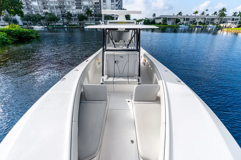 Slide: The Image of 2023 SeaVee 370Z boat on calm water, showcasing spacious seating and sleek design. - 34