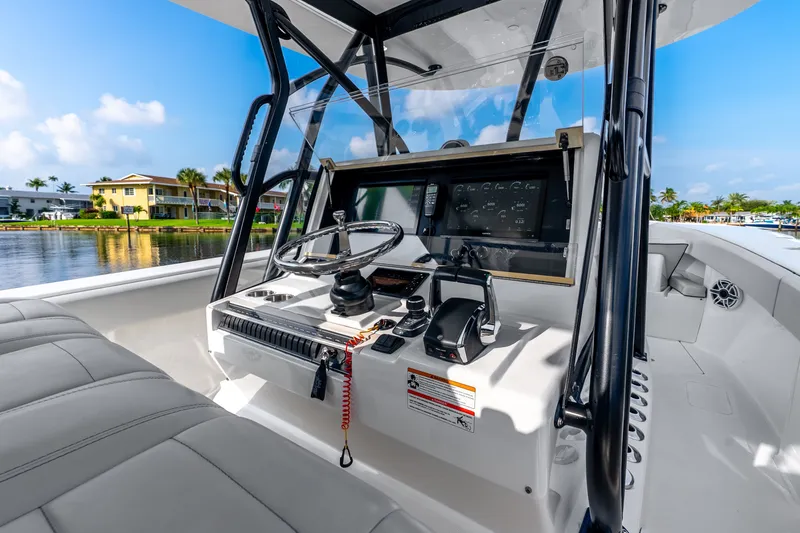 Slide: The Image of 2023 SeaVee 370Z boat cockpit with modern controls and waterfront view. - 43