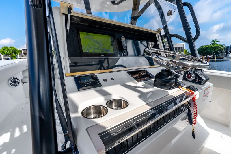Slide: The Image of 2023 SeaVee 370Z boat dashboard with steering wheel, navigation screen, and controls. - 45